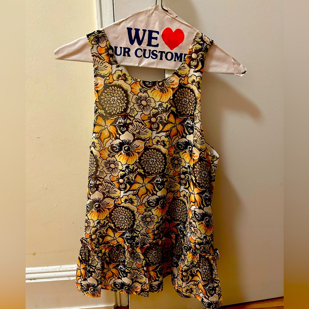 Silk LIKELY sleeveless flower blouse. Cute with white or blue jeans.
